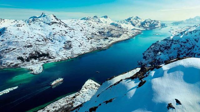 Cruise ship sailing through icy landscape